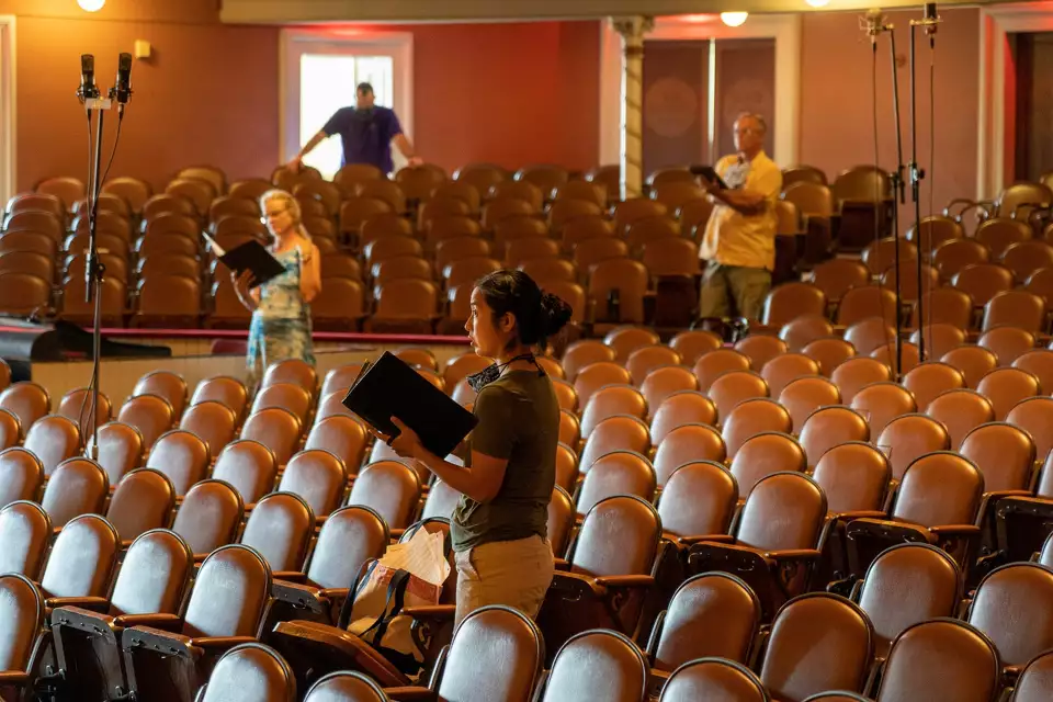 Members of Albany Pro Musica stand in the Troy Savings Bank Music Hal